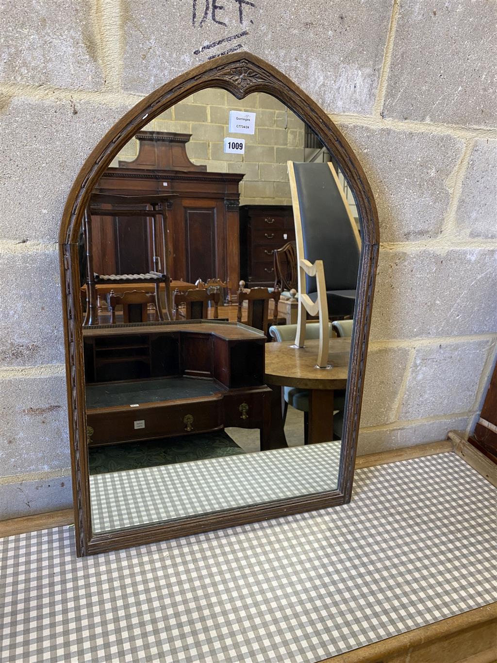 An oak lancet shaped framed wall mirror, (formerly from a dressing table) width 56cm, height 85cm